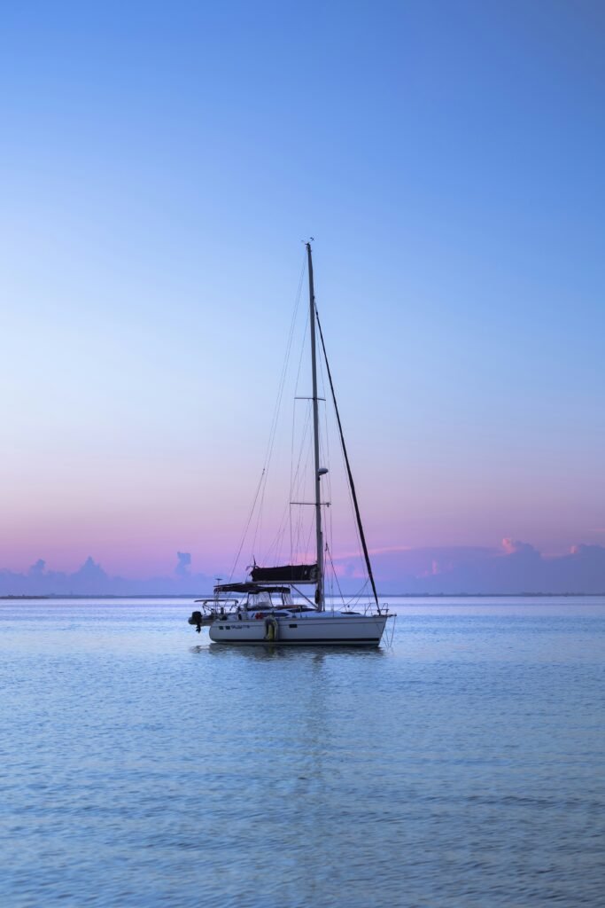 Peaceful sailboat at sunset on the water in Cape Canaveral, Florida, highlighting the coastal lifestyle near homes for sale in Cape Canaveral. Photo by Valeriia Neganova on Unsplash